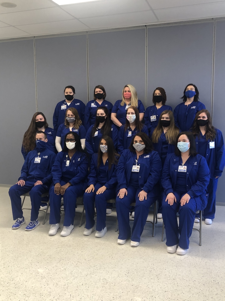 Nursing students in blue scrubs