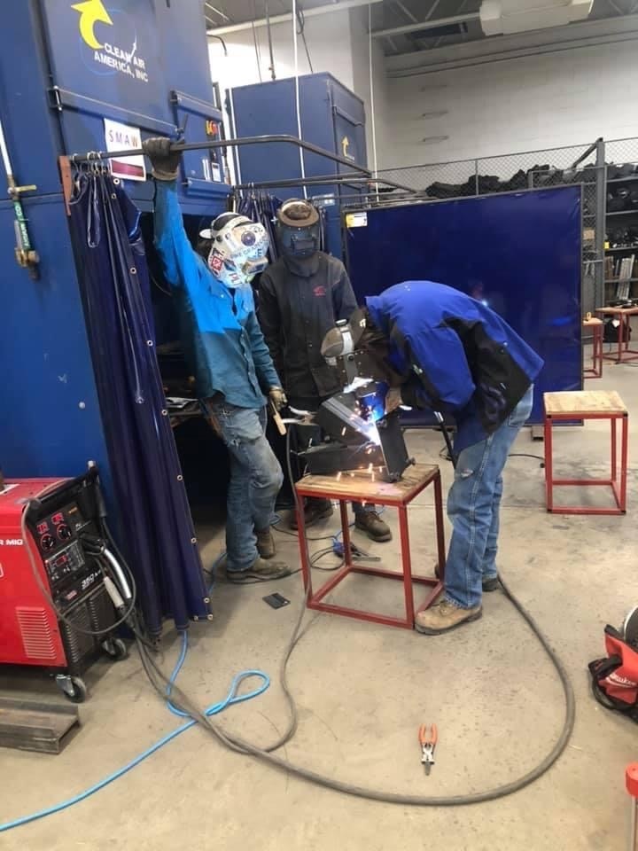 3 welding students working on an project