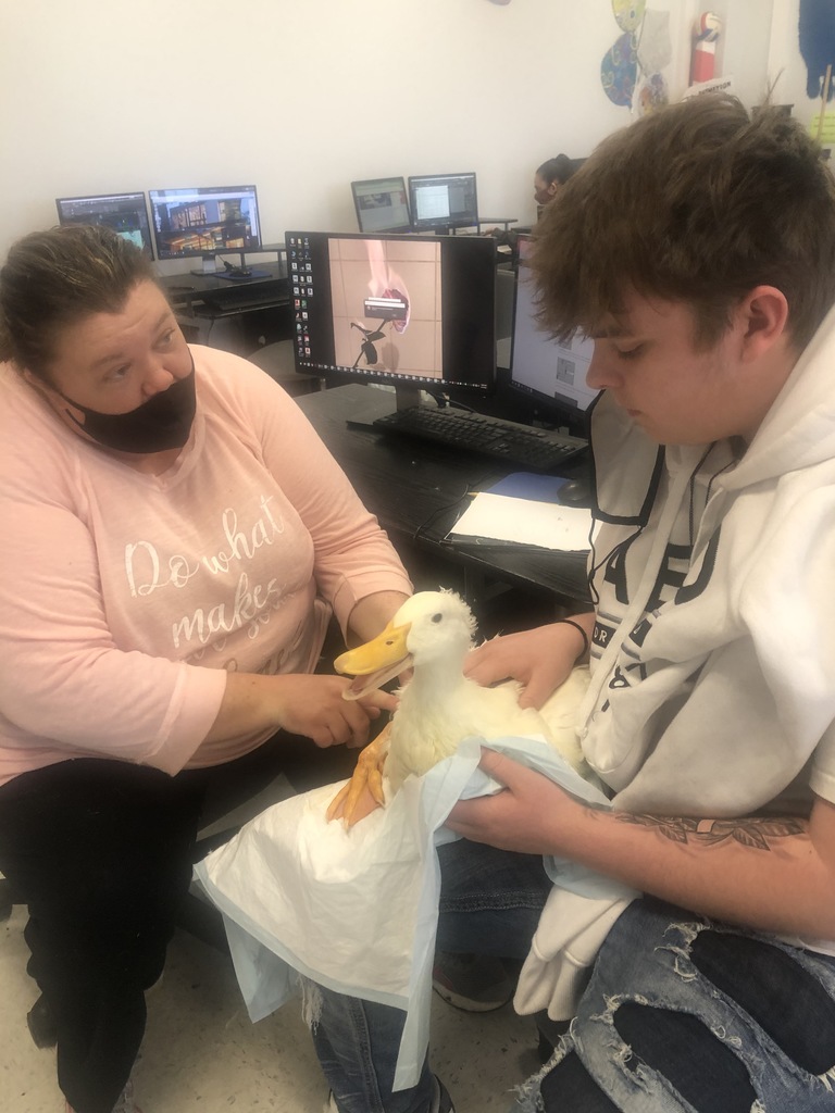 Student and owner holding duck