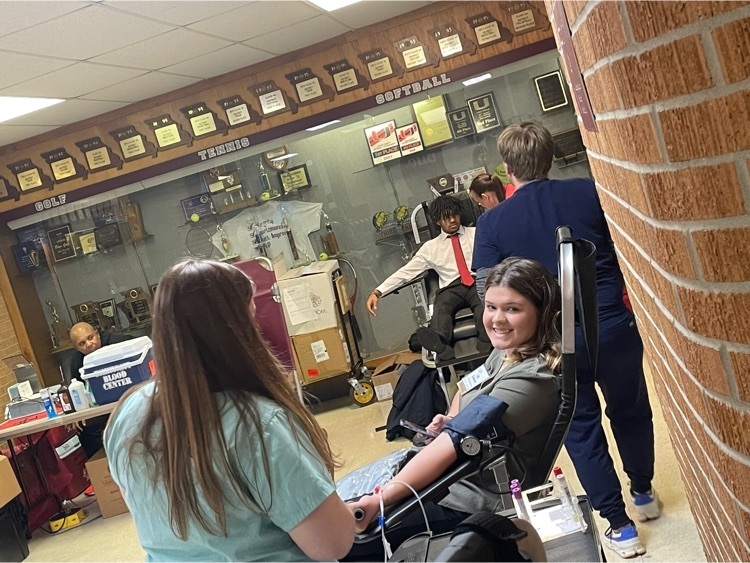 Lily Crosson giving blood at service event. 